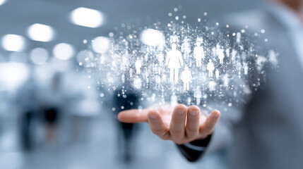 Businessman's hand holding a virtual human icon with a group of people inside on