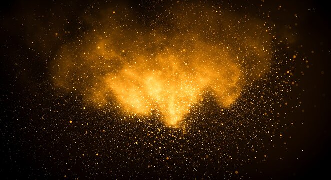 Golden powder explosion with glittering particles in dark background