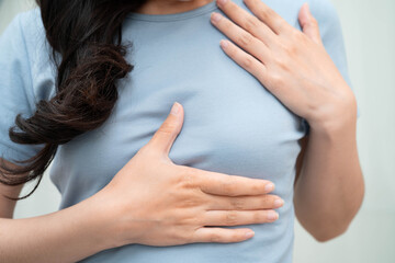 Asian woman self touching check lump or Breast cancer, Breast Self Exam.