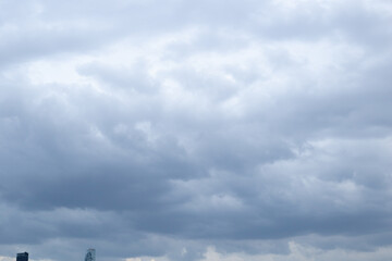 dark blue heavy cloudy rain cloud sky background over city skyline in sunset dusk twilight evening time