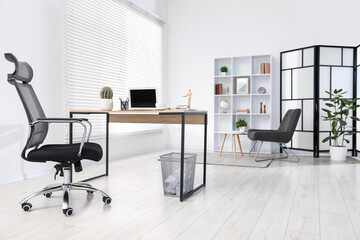 Stylish workplace with modern laptop on wooden desk