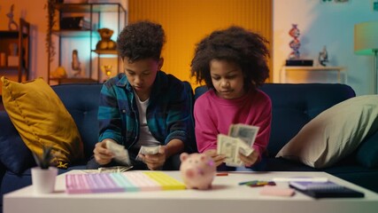 African American siblings counting dollars and hugging, saving money for a dream