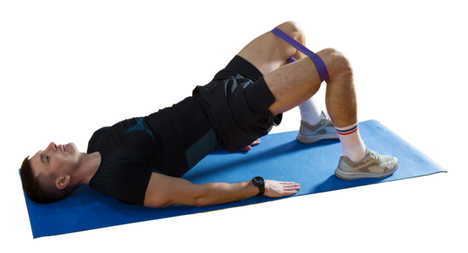 Athletic guy in sportswear and fitness tracker doing exercises in gym.