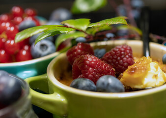 Dessert creme brylee with raspberries, unusual background. Home and restaurant food.