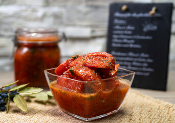 Marinated tomatoes in adjika, an unusual background of the restaurant.