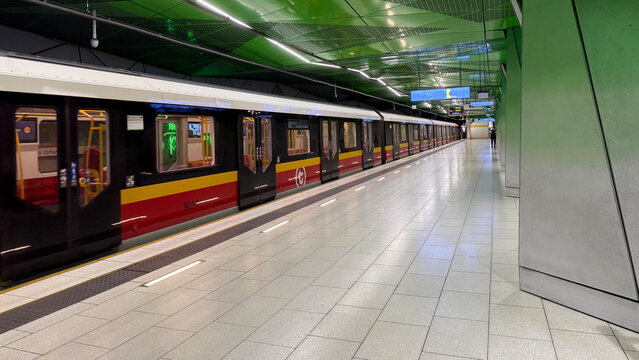 Warsaw, Poland - July 15, 2025: Modern subway train at station with green ceiling and tiled floor