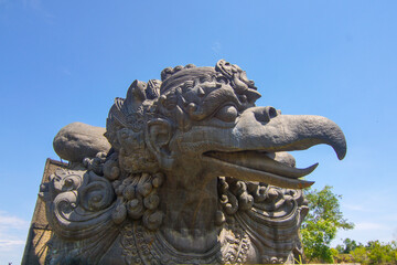 Majestic Garuda Wisnu Kencana Cultural Park Sculpture, Bali Indonesia. Depicts the mythical bird of Garuda, intricate carving detail, sunny blue skies backdrop. Cultural landmark and travel