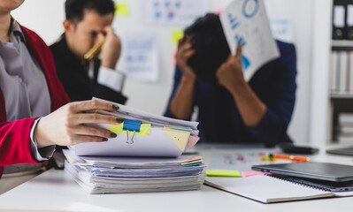 Stressed business team suffering headache and migraine in office meeting, stress from work overload, burnout syndrome, and frustration.