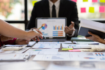 Business consultant meeting is discussing financial chart analysis, marketing growth graph and business planning. Statistical and financial analysis. Discuss the market situation and plan investments.