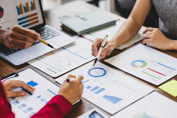 Business people analyzing financial charts and graphs, developing investment strategy for successful business growth.