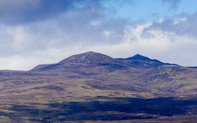 Fototapeta premium The peak of Carn Salachaid which dominates the view from Bonar Bridge in the Scottish Highlands of Sutherland, Scotland, UK