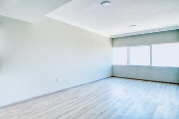 Clean unfurnished apartment interior showcasing spacious layout, raw architectural details, and abundant natural light. 