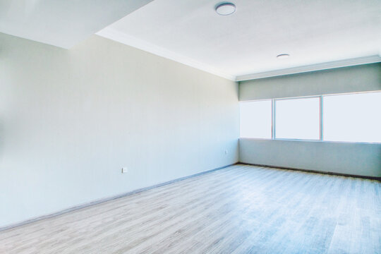 Clean unfurnished apartment interior showcasing spacious layout, raw architectural details, and abundant natural light. 