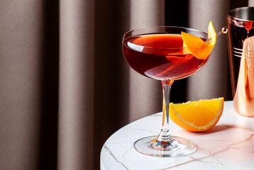 Crafted cocktail with bourbon and coffee liqueur garnished with orange peel