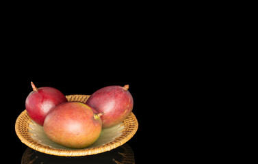 Ripe juicy mangoes on a black background, close-up.