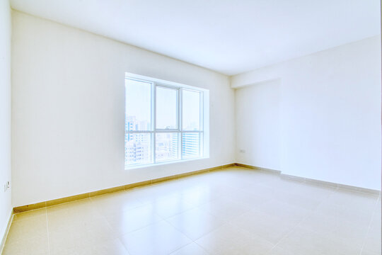 Clean unfurnished apartment interior showcasing spacious layout, raw architectural details, and abundant natural light.