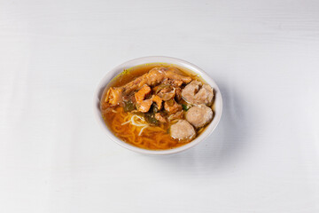Indonesian Cuisine Mie Ayam - Noodles with Meat ball & Chicken Leg. Isolated in White Background