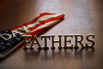 Father's Day Celebration with USA Flag Background and Wooden Letters