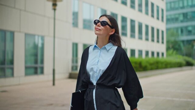 Businesswoman goes with a folder to the office in Courbevoie Paris. business centers and high-rise financial buildings, company offices woman goes to work.