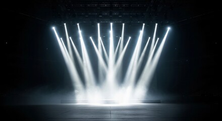 Dramatic stage lighting with bright spotlights creates an energetic atmosphere for performances and events