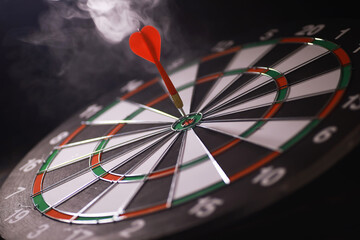 Bullseye Dart in the Center of a Dartboard with Smoke