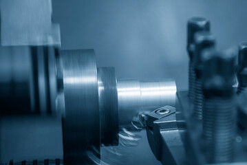 Closeup scene the lathe machine rough cut the metal parts in the blue tone scene.