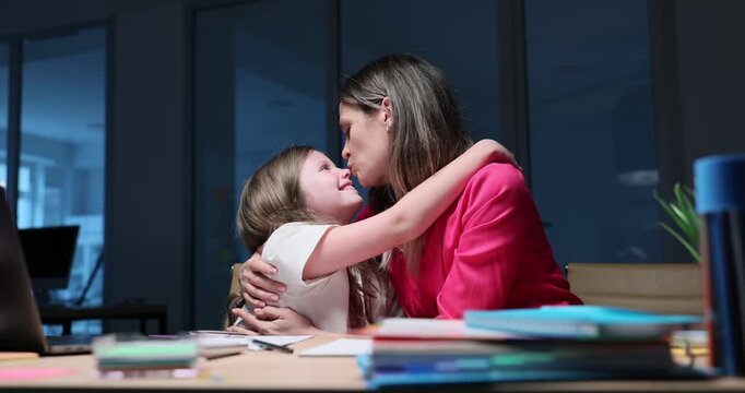 Mother hugs girl sitting close kissing daughter nose creating intimate bond. Child touches woman with trust feeling calm and connected slow motion