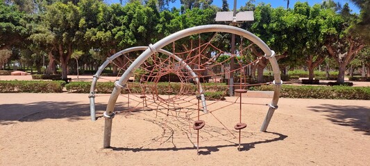 Climbing dome with red netting inviting children to play in park playground