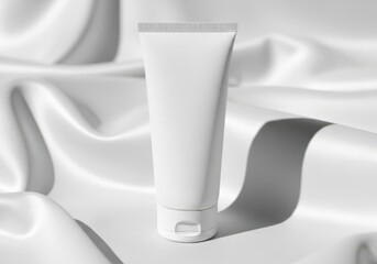White cosmetic cream tube on soft fabric