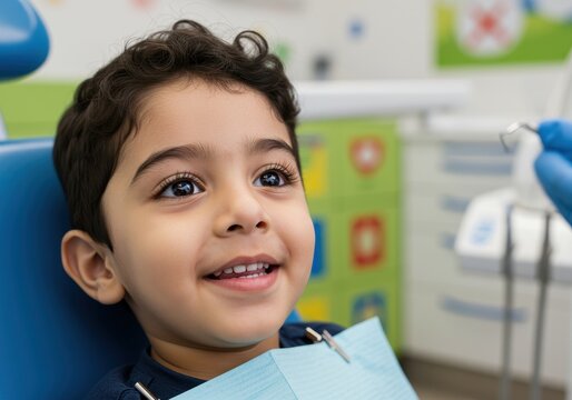 smiling middle eastern child sitting in chair with colorful dental office background. pediatric visit, health care concept. stomatology print design, health brochure.