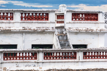 Architectural details of a weathered building in Kallidaikurichi with distinct stairway and balcony features