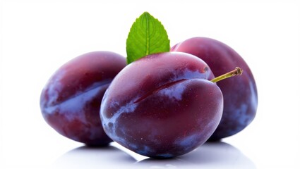 Obraz premium Three fresh purple plums isolated on white background