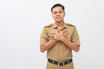Relieved indonesian civil servant employee holding chest while closing her eyes