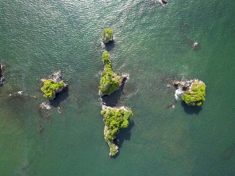 Aerial view of the stark green islets standing out against the deep blue sea, a serene contrast of nature's artistry, Limbe, Southwest Region, Cameroon.