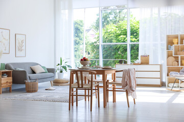 Stylish table setting, chairs and decor in dining room. Interior design