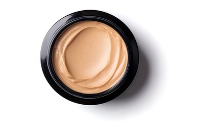 A close-up of a jar of creamy foundation with a smooth texture, showcasing a light beige color suitable for makeup application.