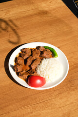 Fried meatballs and rice with fresh tomato and pepper garnish. Turkish main dish. comfort lunch.