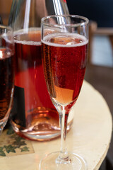 Pouring and tasting of rose or pink cuvee sparkling wine brut, grand reserve, champagne in Ay-Champagne wine making village in Vallee de la Marne, , Champagne region, France