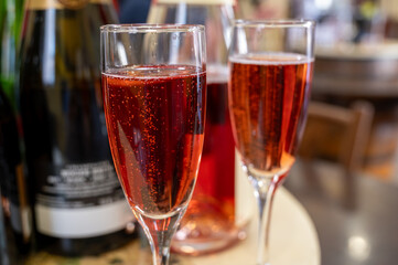 Pouring and tasting of rose or pink cuvee sparkling wine brut, grand reserve, champagne in Ay-Champagne wine making village in Vallee de la Marne, , Champagne region, France