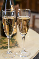 Pouring and tasting of dry sparkling wine brut, grand reserve, champagne in Ay-Champagne wine making village in Vallee de la Marne, , Champagne region, France