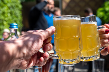 Belgian beer in glasses in old brewery in Bruges, light or dark, tasty beverage, lunch with beer, tourist destination, Flanders, Belgium