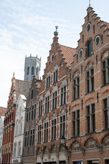 Obraz premium Medieval houses facades and rooftops and city tower with bells in the centre of Bruges, Flanders