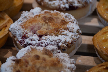 Fresh baked buttered fruit and sweet buns, cakes, pastries in artisan bakery early morning in Bruges, Belgium