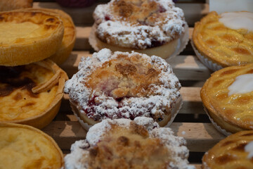 Fresh baked buttered fruit and sweet buns, cakes, pastries in artisan bakery early morning in Bruges, Belgium