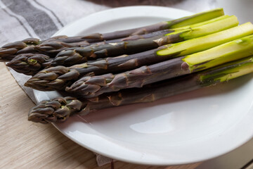 Garden or farm to table concept, fresh organic purple asparagus vegetables, seasonal foood, tasty healthy food