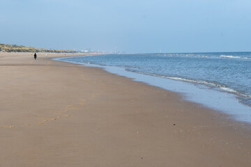 White sandy beach in cosy seaside holiday village on North Sea, built in belle epoque style in Flanders, De Haan or Le Coq sur Mer, Belgium