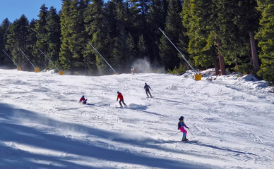 Winter season at Bansko ski resort in Bulgaria with a view to the skiers having fun on the slope