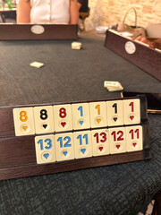 Rummikub game table with numbered tiles in play. strategy moment. board game setup.