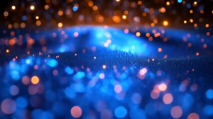 Blue textured surface with glowing orbs of blue and orange creating depth and a sense of movement - Powered by Adobe