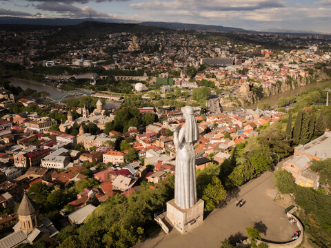 Aerial view of the Kartlis Deda statue standing guard over the city, with the Kura River snaking through the landscape, Tbilisi, Tbilisi, Georgia.